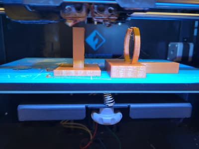 A close-up shot of a 3D printed plastic part replacing an original broken component, lying next to a screwdriver and other tools.