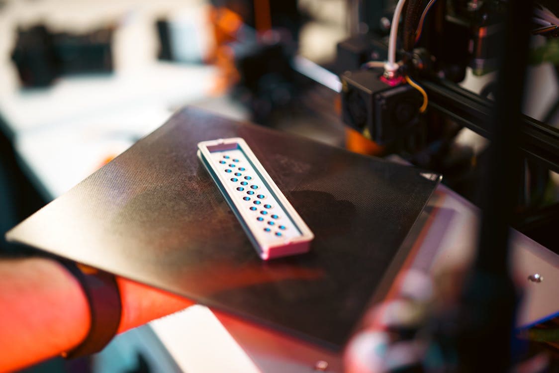 Close-up of an FDM 3D printer in operation — demonstrating additive manufacturing precision in a workshop