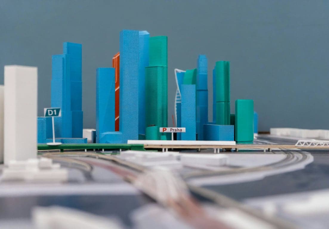 A detailed 3D printed architectural model of a city, showcasing the technology's use for project visualization.